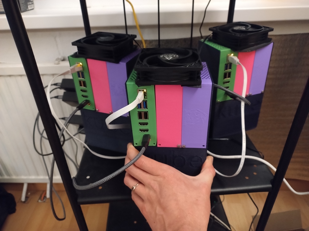 An overview of 3 brightly colored small 3D-printed computer cases, each composed of 3 modules. The left module in each case has some USB and HDMI ports, and is connected with a USB-C cable and an RJ45 connector.