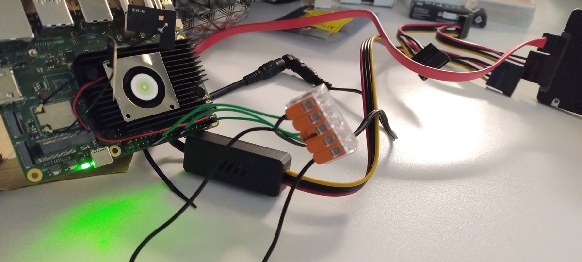 The bare SBC on the desk, connected to the Dupont wires and the SATA data cable, demoing that the setup works